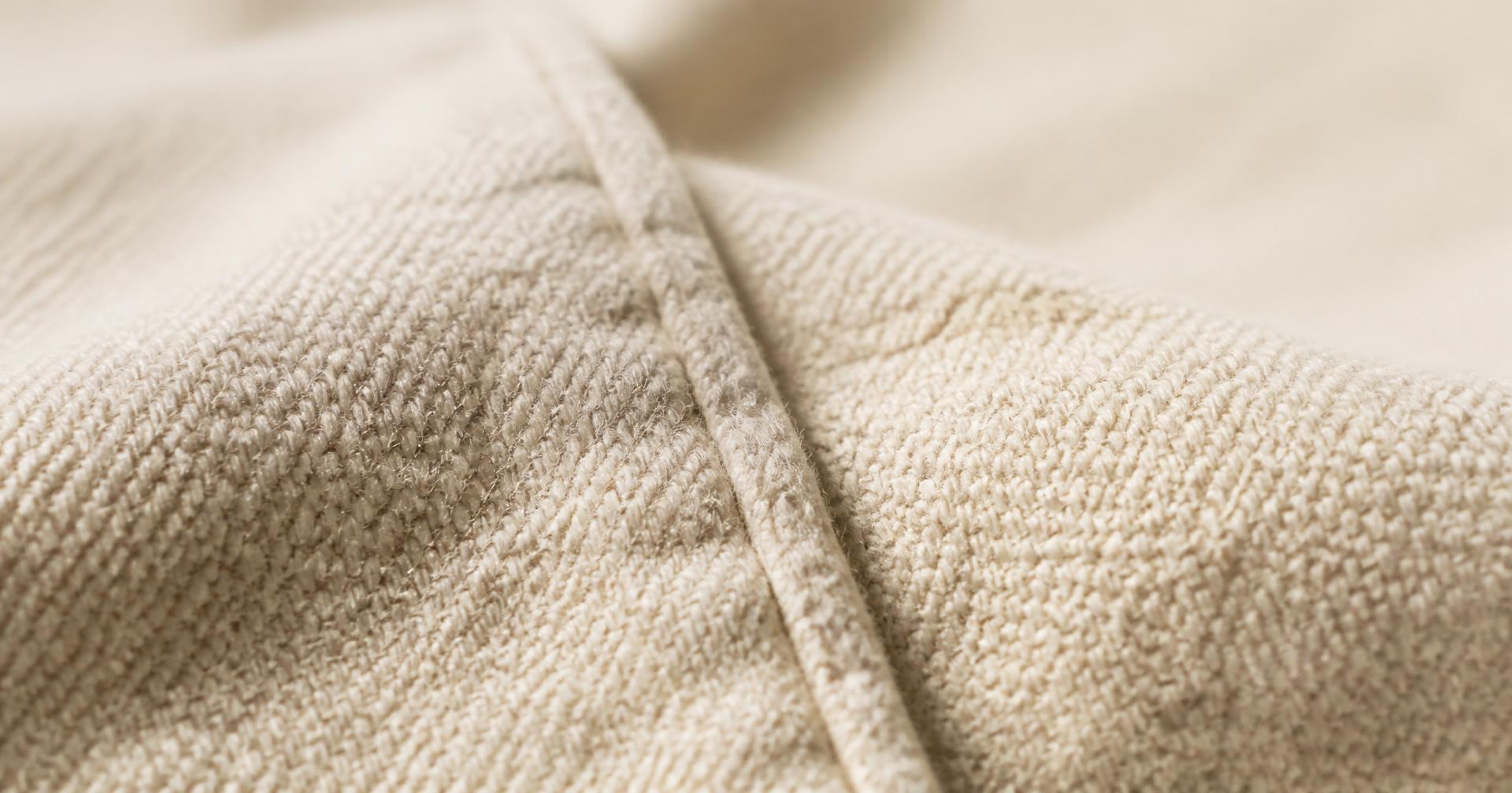 Close-up of a natural undyed woven cotton seam
